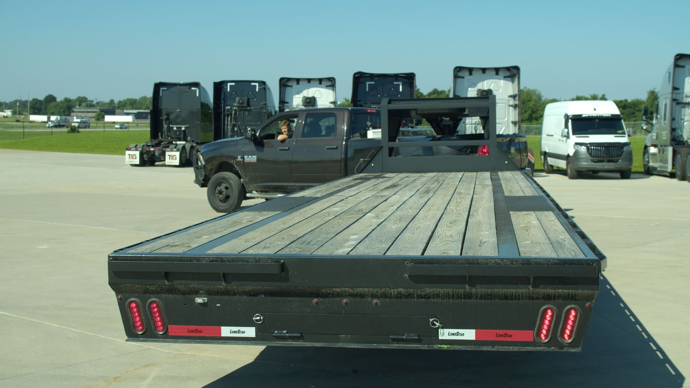 An Onyx Logistics driver checking back from the cab of a hotshot rig